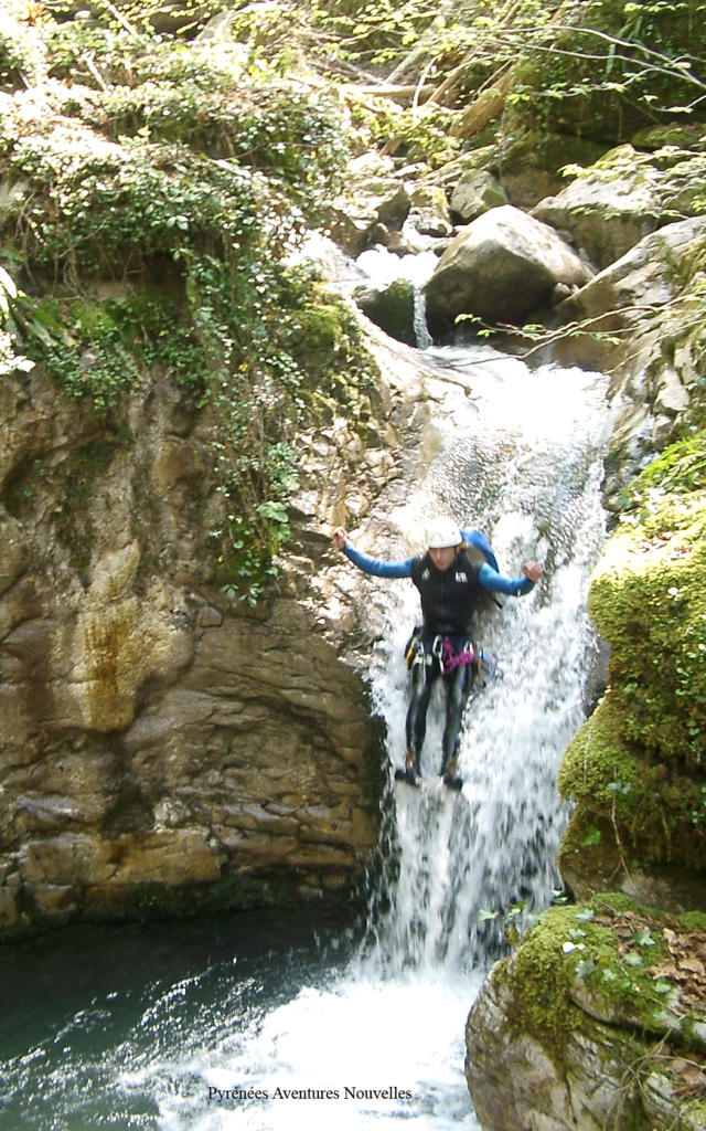 Une personne fait du canyoning dans un ruisseau