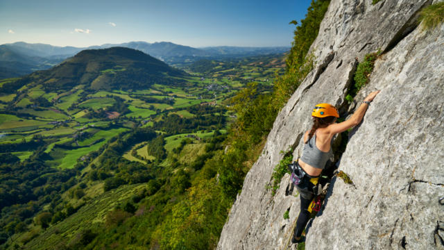 Une sportive escalade la falaise d'Arguibelle à Lanne en Baretous